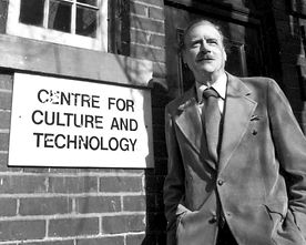 Marshall McLuhan outside the historic Coach House with the sign: Centre for Culture and Technology